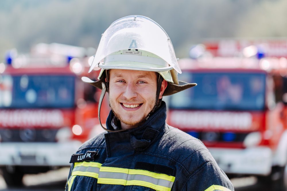 Feuerwehrmann im Portrait mit Feuerwehrhelm